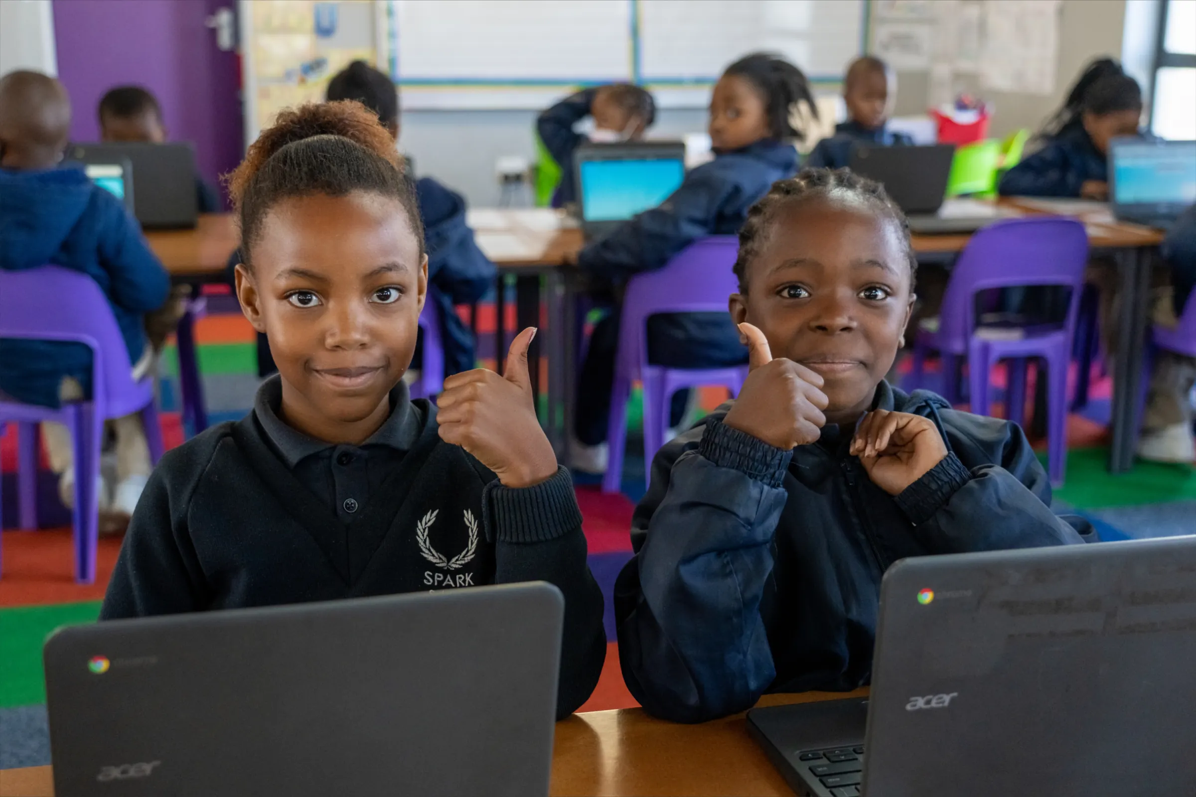 SPARK Schools pupils working on laptops in a classroom